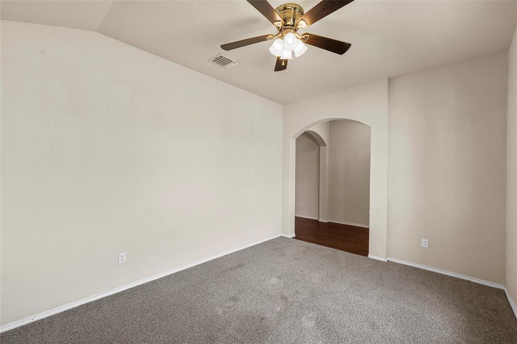 3217 Beutel Road Lorena, TX 76655 - Photo 8 of 40 Unfurnished room with dark colored carpet, arched walkways, and a ceiling fan