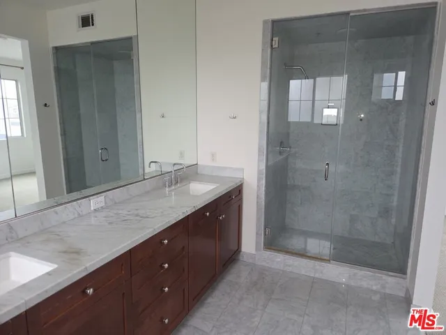 a white toilet sitting next to a shower