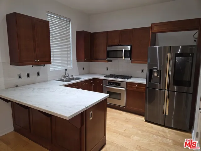 a kitchen with a refrigerator sink and microwave