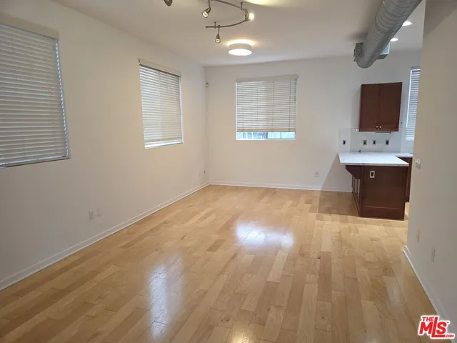 a view of storage and utility room with wooden floor
