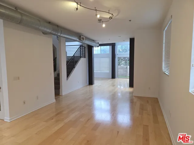 a view of hallway with wooden floor