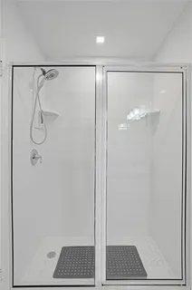 a bathroom with a glass shower door