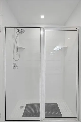 a bathroom with a glass shower door