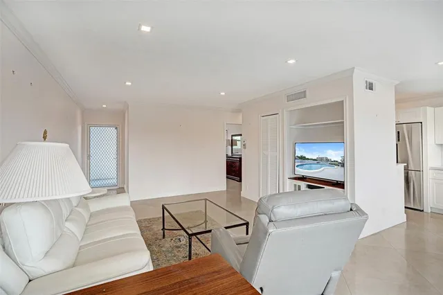 a living room with furniture and kitchen view