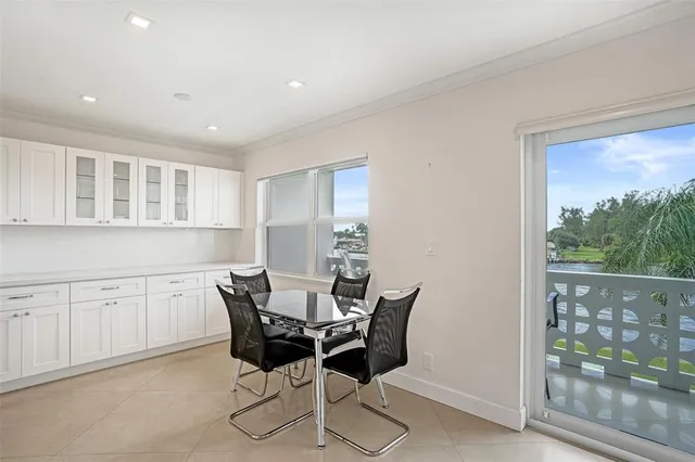 a view of a dining room with furniture and a window