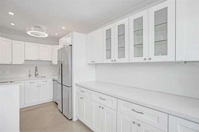 a kitchen with white cabinets and appliances
