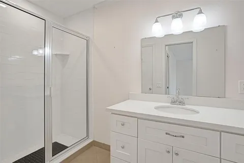a bathroom with a sink vanity and a mirror