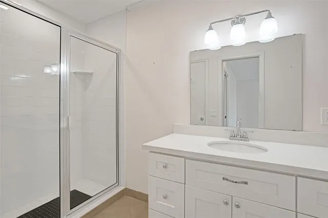 a bathroom with a sink vanity and a mirror
