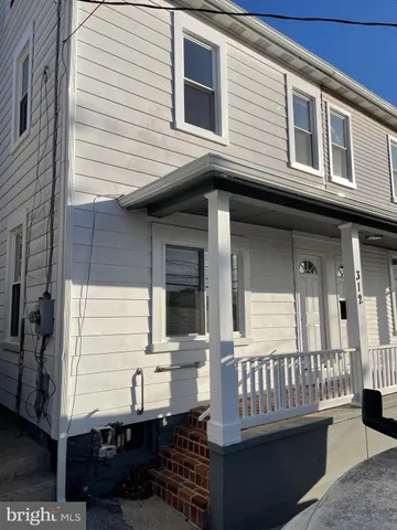 a view of a house with a wooden deck