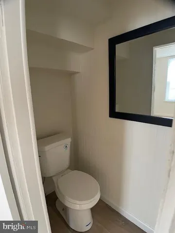 a white toilet sitting next to a small sink