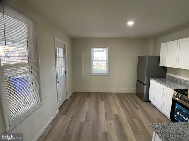 a view of a kitchen with a sink wooden floor and a window