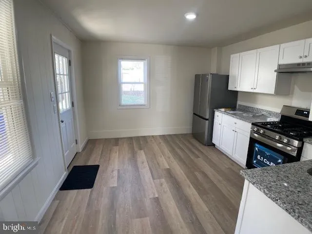 a kitchen with wooden floors and a stove