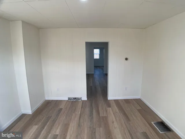 a view of a room with wooden floor