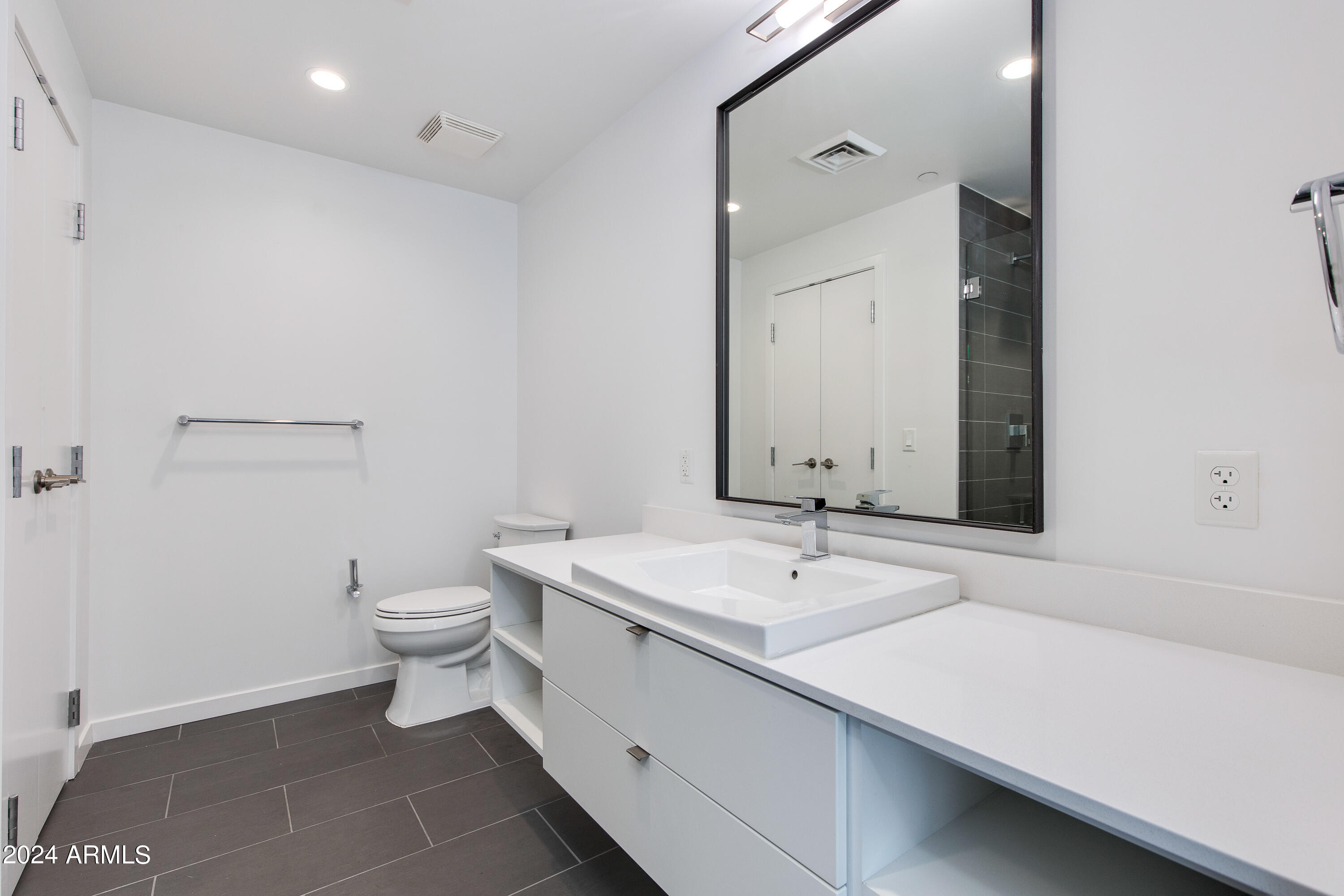 200 West Portland Street, Unit 511 Phoenix, AZ 85003 - Photo 11 of 19 a bathroom with a sink a toilet and mirror
