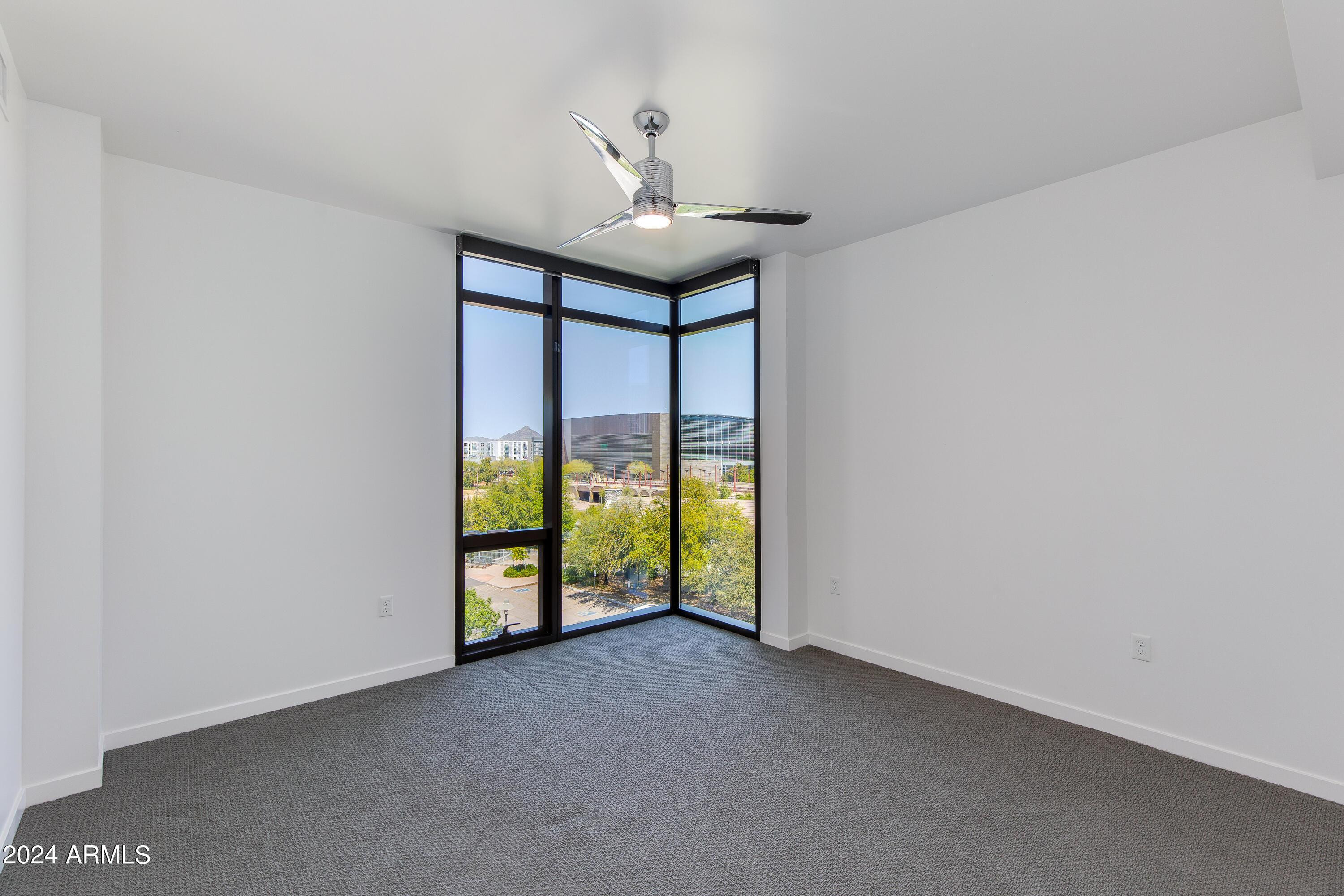 200 West Portland Street, Unit 511 Phoenix, AZ 85003 - Photo 6 of 20 a view of an empty room with chandelier fan