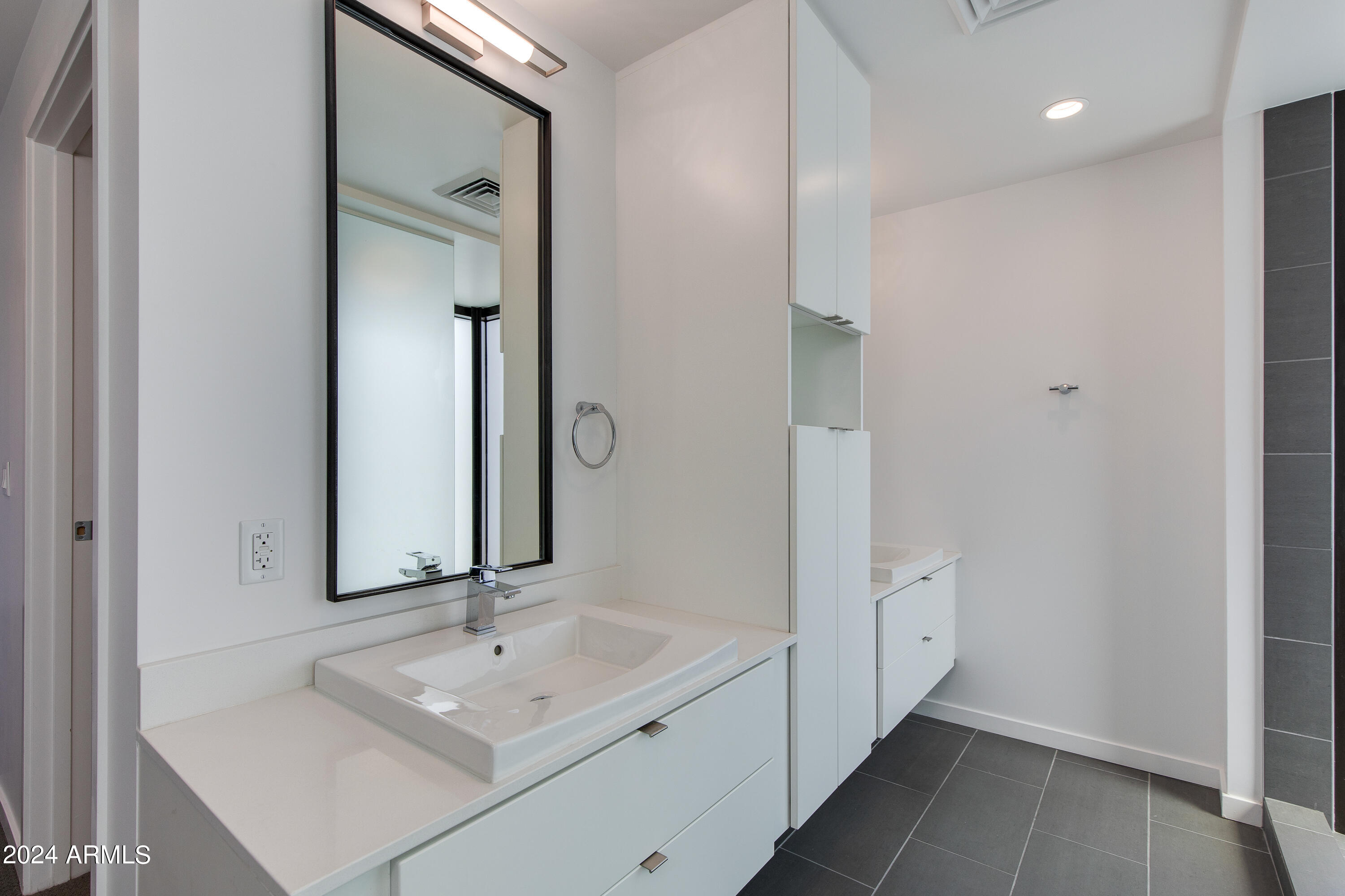 200 West Portland Street, Unit 511 Phoenix, AZ 85003 - Photo 8 of 19 a bathroom with a sink and a mirror