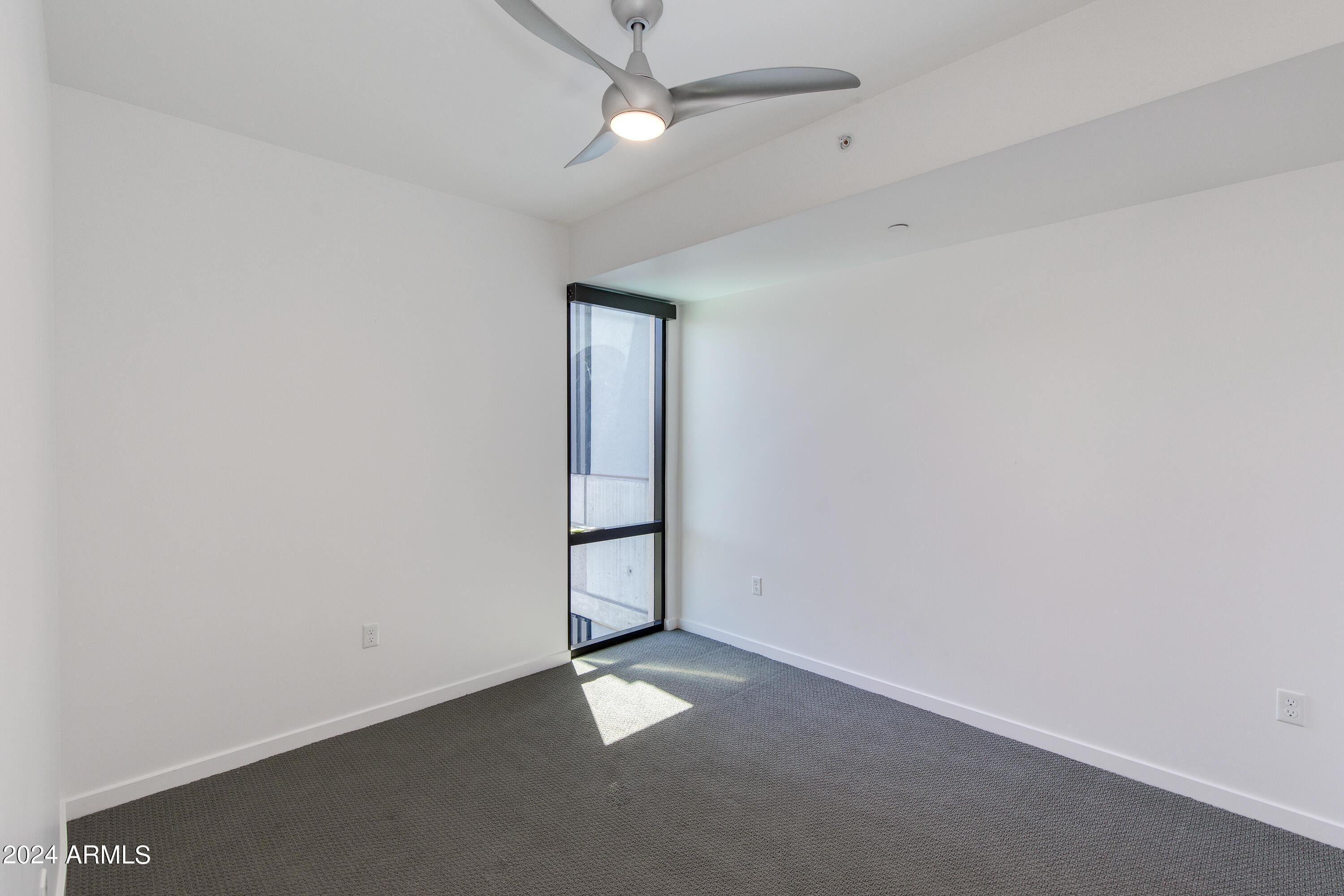 200 West Portland Street, Unit 511 Phoenix, AZ 85003 - Photo 10 of 20 an empty room with a empty space and a ceiling fan