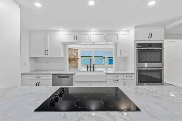 a kitchen with a sink stove and refrigerator