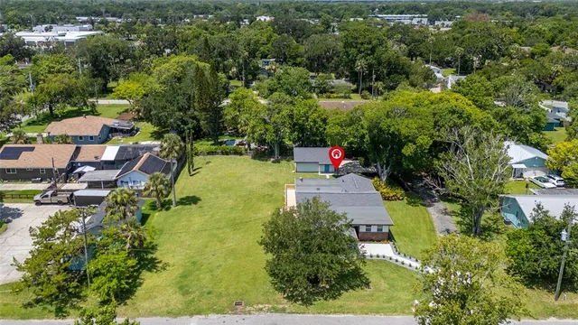 an aerial view of a house with a yard basket ball court and outdoor seating