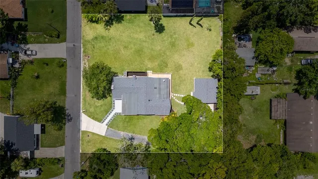 an aerial view of a house with a yard