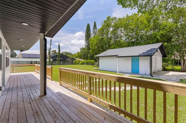 a view of a wooden deck next to a yard