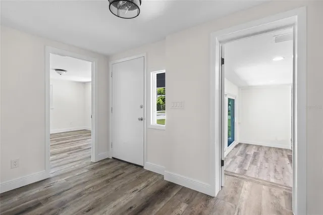 a view of an empty room and wooden floor
