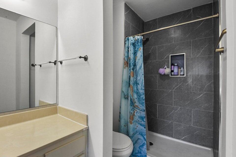 6335 Riverwalk Lane, Unit 3 Jupiter, FL 33458 - Photo 11 of 20 a bathroom with a shower and a sink