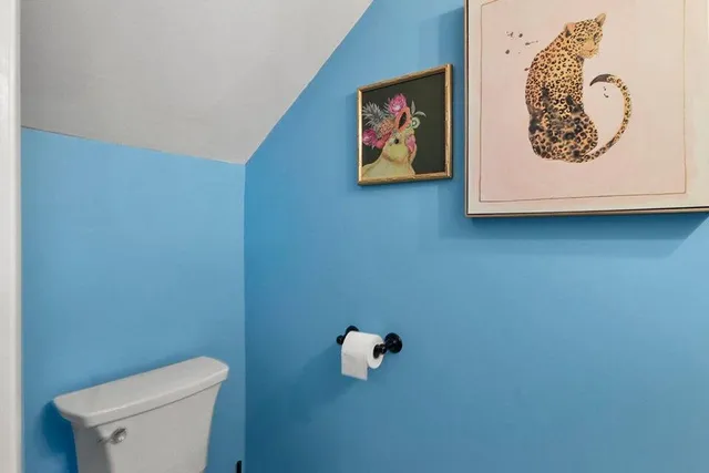 a white wall with a toilet