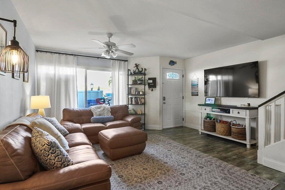 6335 Riverwalk Lane, Unit 3 Jupiter, FL 33458 - Photo 4 of 20 a living room with furniture and a flat screen tv