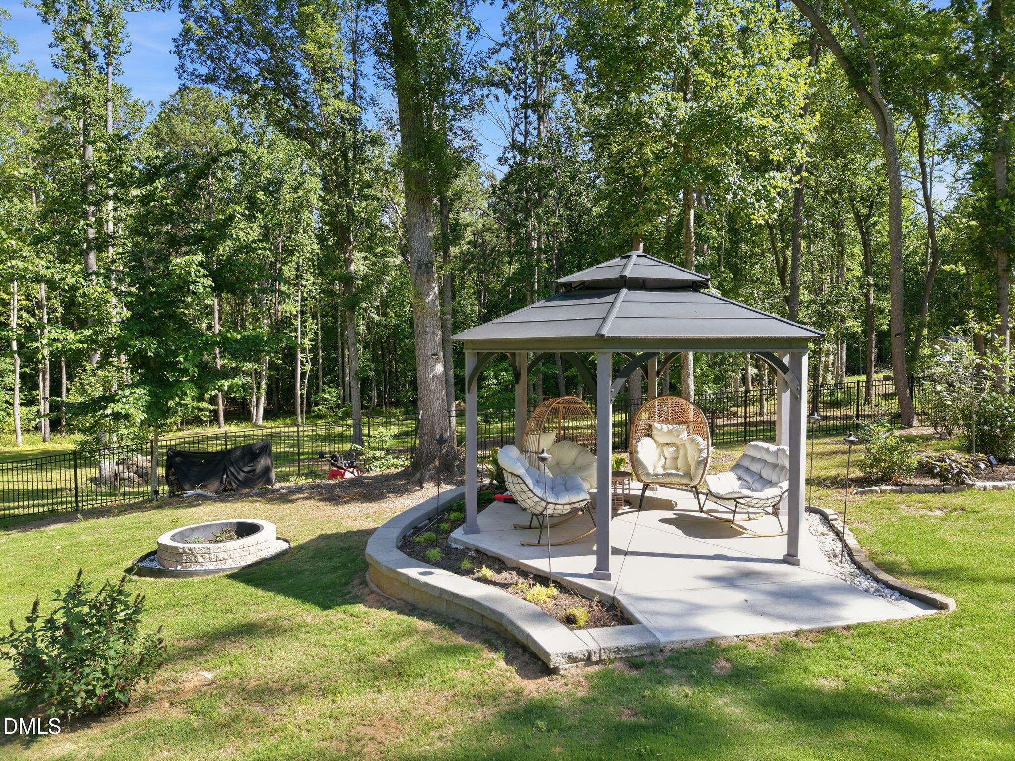 3511 Bruce Garner Road Wake Forest, NC 27587 - Photo 51 of 56 a view of backyard with table and chairs under an umbrella
