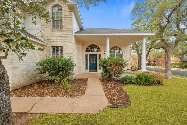 a front view of a house with garden