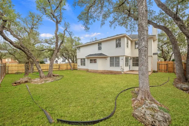 a view of a white house with a yard porch and sitting area