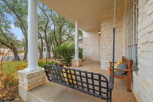 a view of a patio with a table and chairs and potted plants