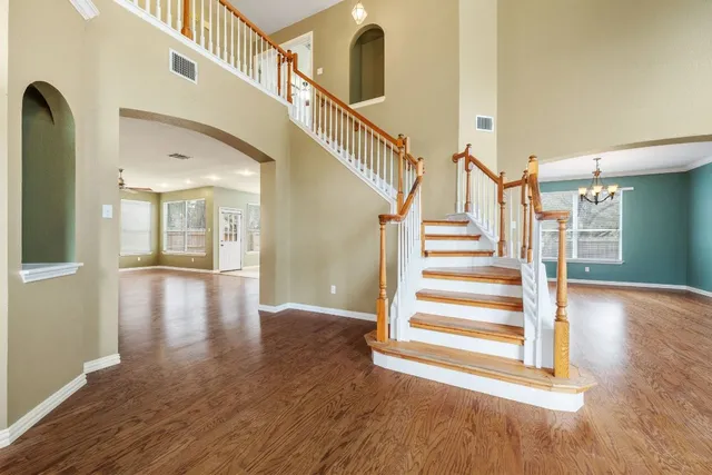 a view of entryway and hall with wooden floor