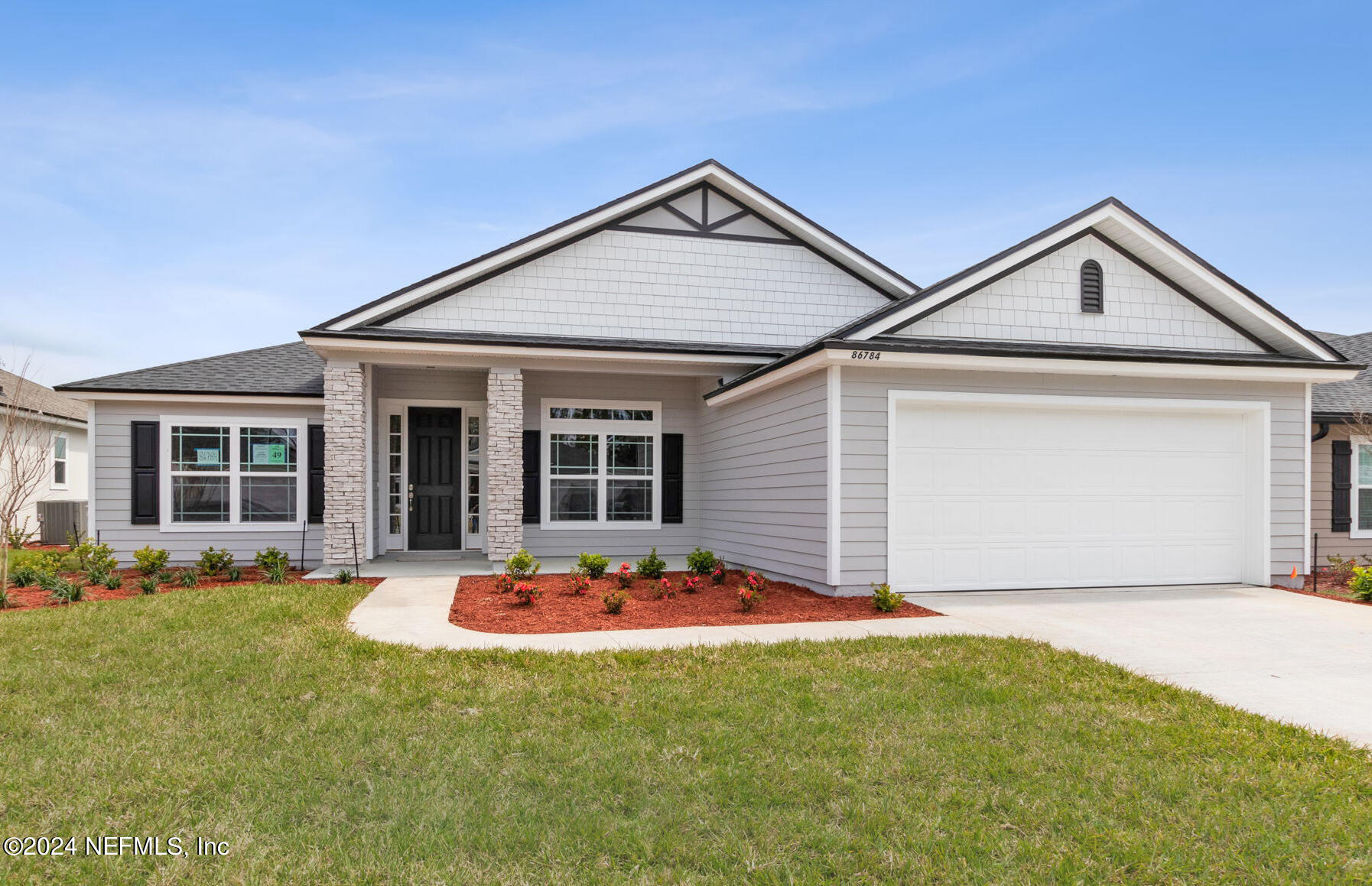 a front view of house with yard outdoor seating and garage
