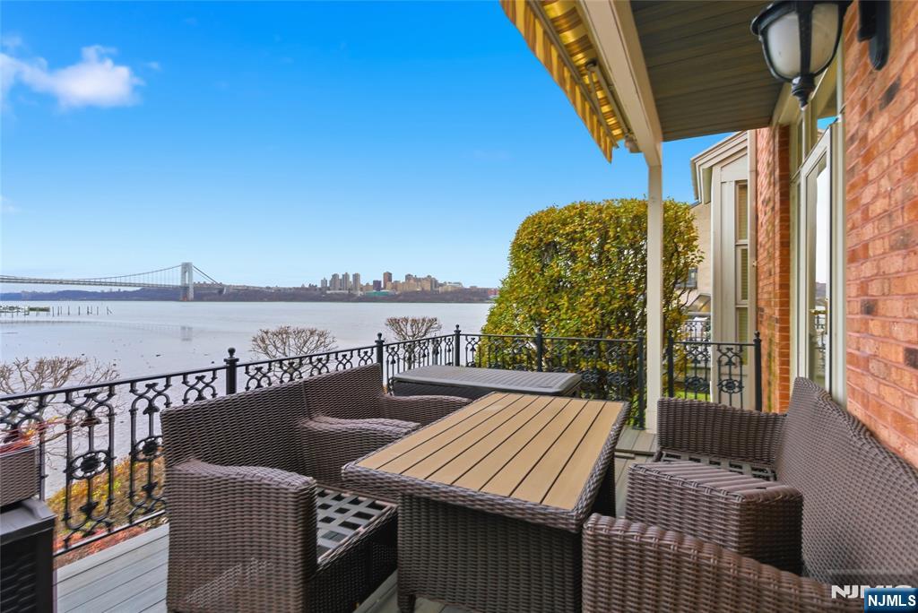 119 Hudson Cove Edgewater, NJ 07020 - Photo 12 of 44 a view of a balcony with wooden floor and iron stairs