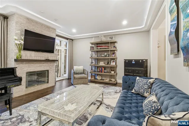 a living room with furniture a flat screen tv and a fireplace