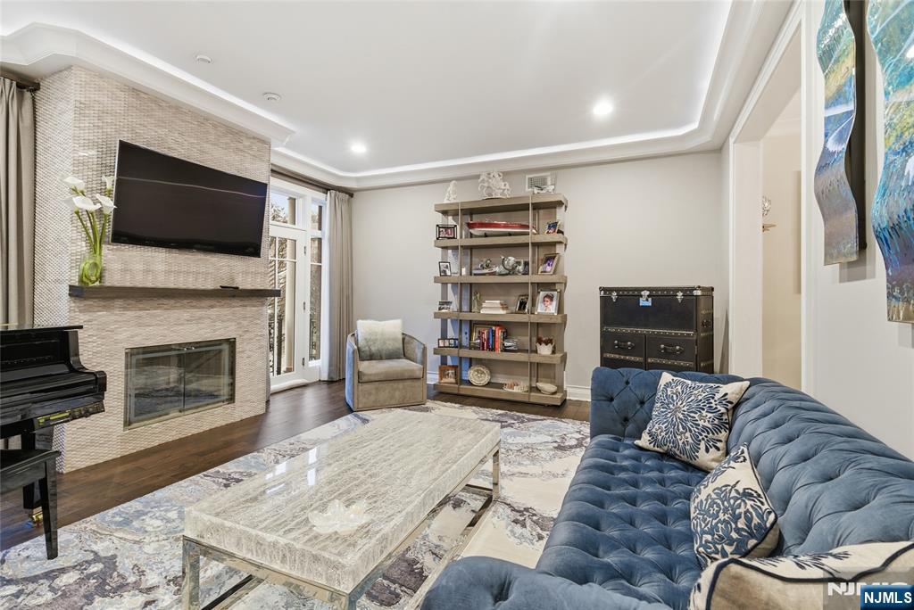 119 Hudson Cove Edgewater, NJ 07020 - Photo 15 of 44 a living room with furniture a flat screen tv and a fireplace