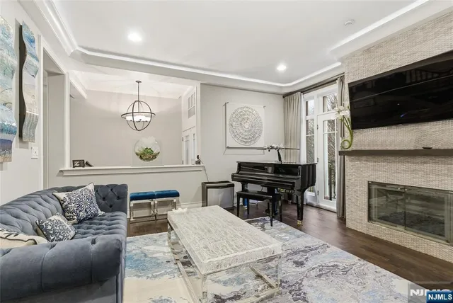 a living room with furniture a flat screen tv and a fireplace