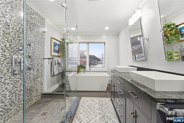 a bathroom with a granite countertop sink a toilet a mirror and shower