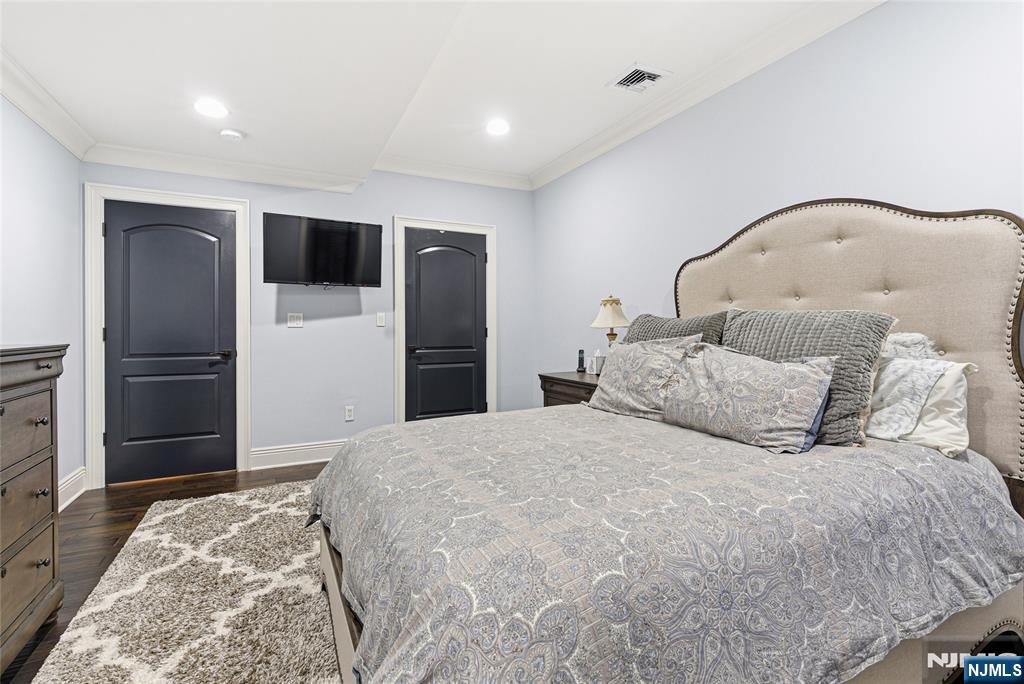 119 Hudson Cove Edgewater, NJ 07020 - Photo 34 of 44 a bedroom with a large bed and a refrigerator