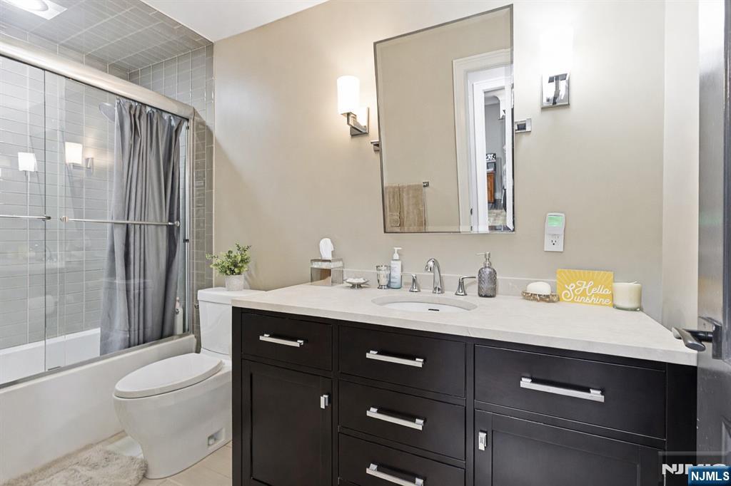 119 Hudson Cove Edgewater, NJ 07020 - Photo 35 of 44 a bathroom with a granite countertop sink toilet and shower