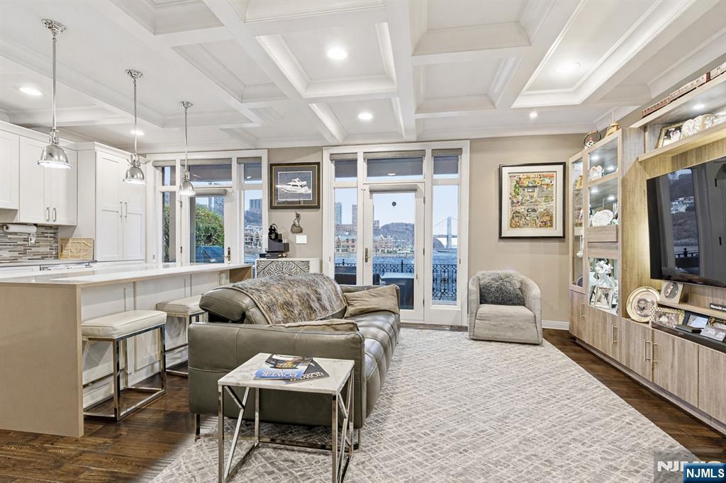 119 Hudson Cove Edgewater, NJ 07020 - Photo 4 of 44 a living room with furniture a flat screen tv and a large window