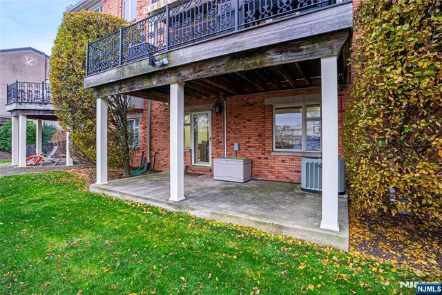 a view of a house with a small yard and wooden fence