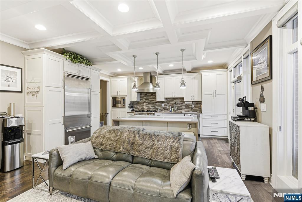 119 Hudson Cove Edgewater, NJ 07020 - Photo 10 of 44 a living room with stainless steel appliances furniture a rug and a kitchen view