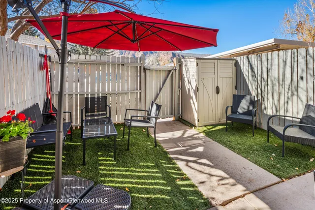 a view of a backyard with sitting area