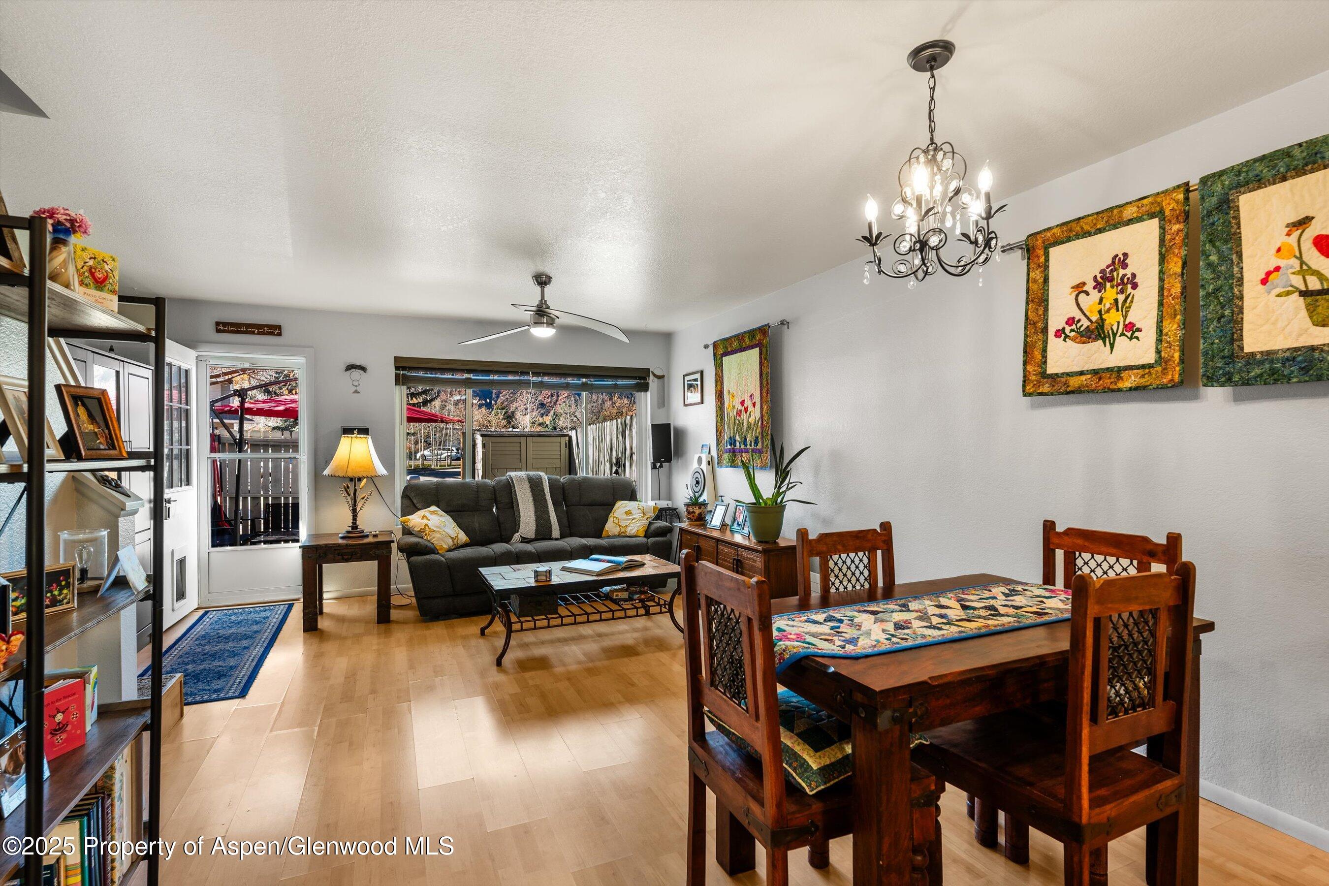 323 Park Avenue, Unit G2 Basalt, CO 81621 - Photo 13 of 25 a living room with lots of furniture and a chandelier