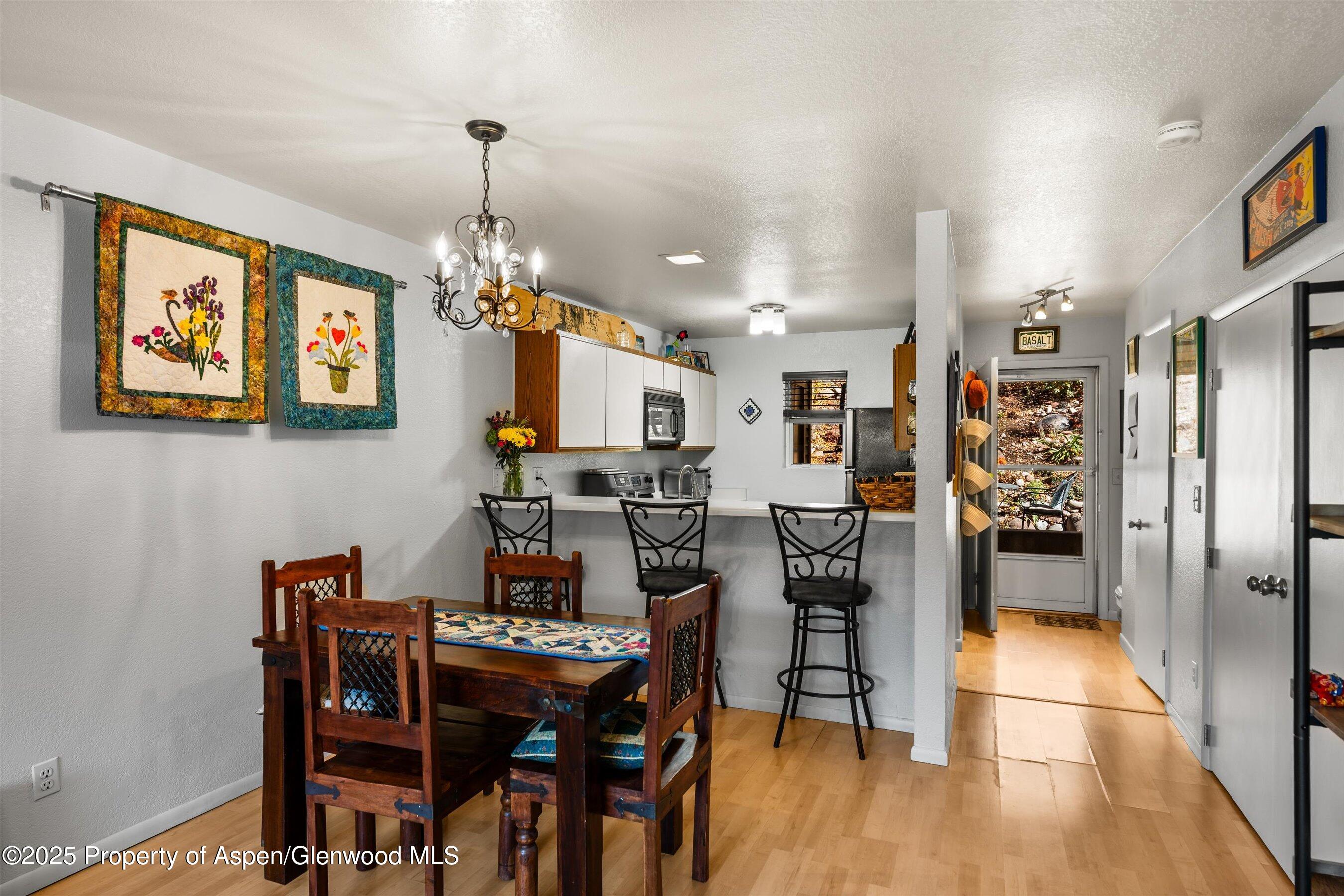 323 Park Avenue, Unit G2 Basalt, CO 81621 - Photo 2 of 17 a view of a dining room with furniture and chandelier
