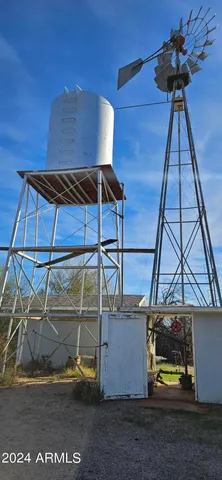 a view of a house with wooden deck and furniture