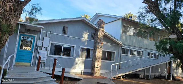 a view of a house with backyard and sitting area